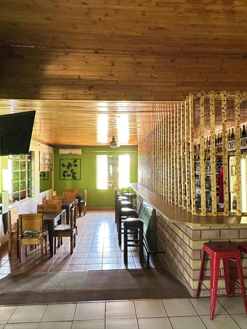 Wooden lounge bar interior at Tse Yaa Kuku with bar counter seating